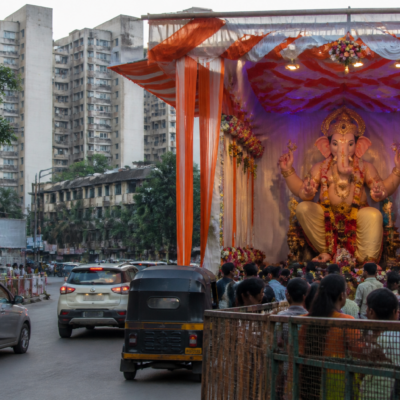 Ganeshotsav mandap occupying part of a road in Mira Bhayandar, with traffic passing through the remaining space