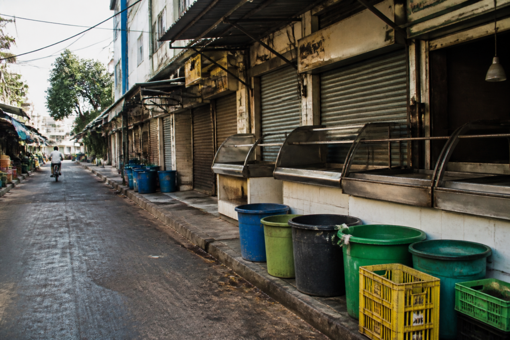 Chicken vendors and waste containers outside a Bengaluru poultry shop during a protest over the Bengaluru chicken waste tax