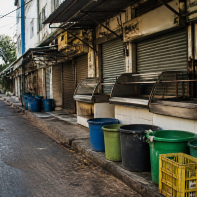 Chicken vendors and waste containers outside a Bengaluru poultry shop during a protest over the Bengaluru chicken waste tax