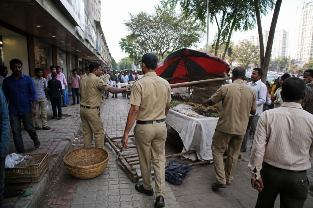Navi Mumbai municipal workers conducting an encroachment drive near a Vashi footpath
