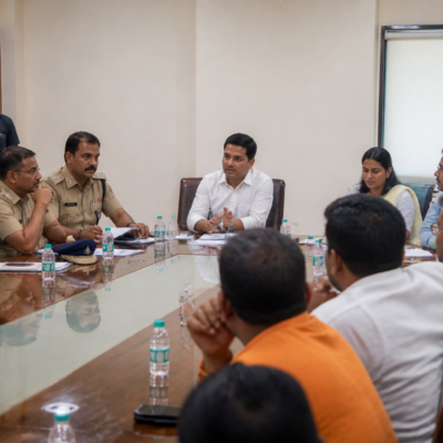 Police and municipal officials reviewing Vasai-Virar Ganeshotsav safety and sound pollution arrangements at a meeting