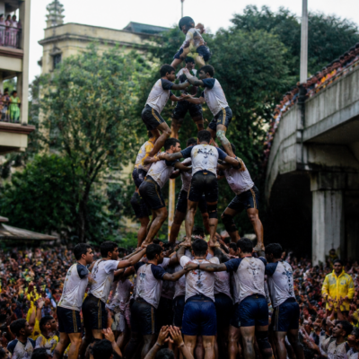 Govinda participants forming a human pyramid during a Dahi Handi celebration in Thane