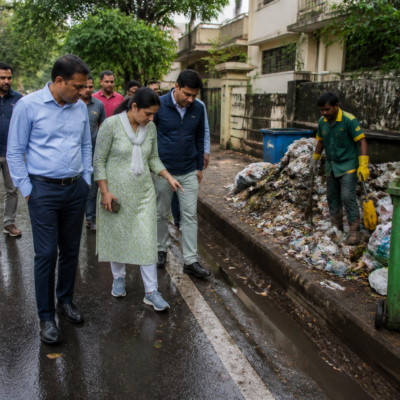 Civic workers and officials inspecting waste management and road conditions in Bengaluru