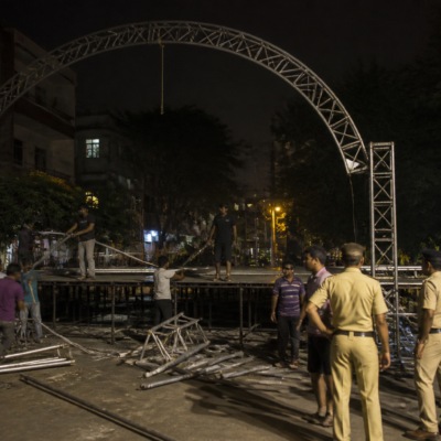 Temporary Dahi Handi event stage structure being dismantled at night in Old Sangvi, Pimpri-Chinchwad