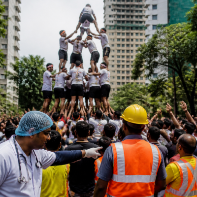Govinda participants forming a human pyramid during a Dahi Handi festival in Thane
