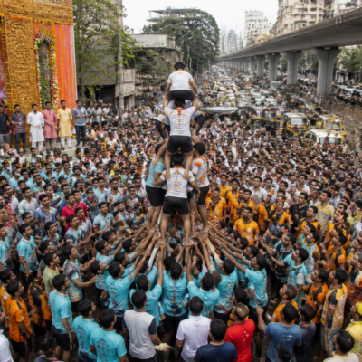 Govinda teams gather on a traffic-diverted road during Thane Dahi Handi celebrations