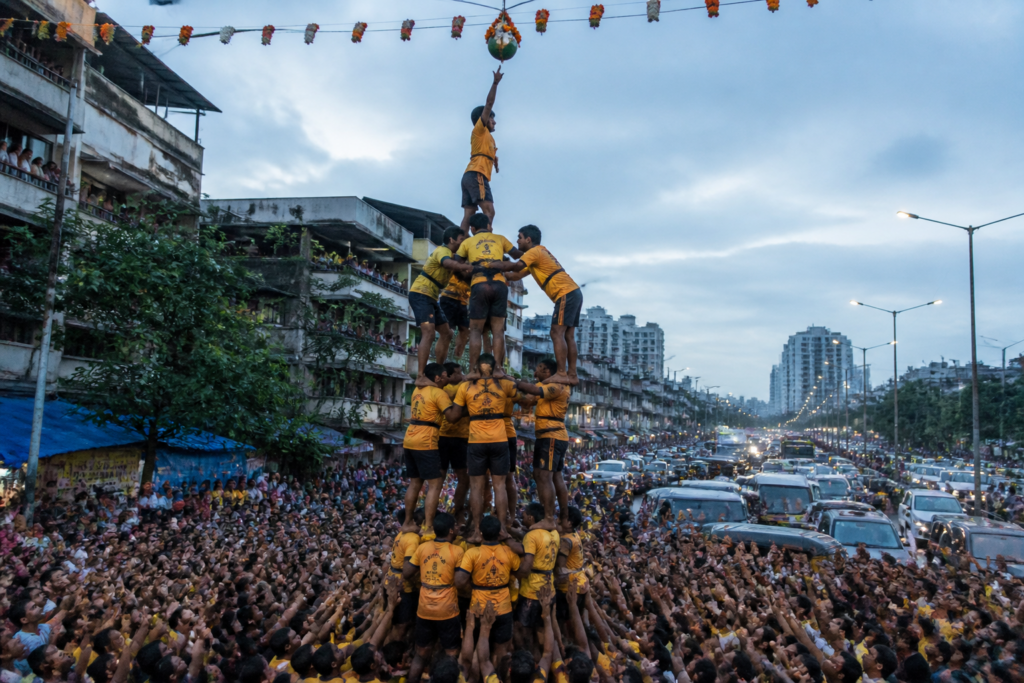 Govinda team forming a human pyramid during a crowded Vasai-Virar Dahi Handi celebration