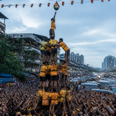 Govinda team forming a human pyramid during a crowded Vasai-Virar Dahi Handi celebration