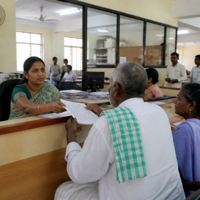 Officials receiving public grievances at a Praja Seva campaign meeting in Karnataka