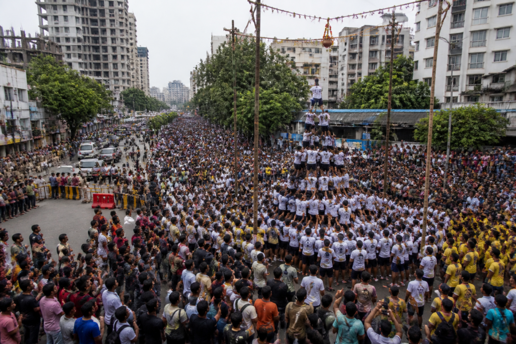 Govinda teams gather near a road closure during Dahi Handi celebrations in Thane