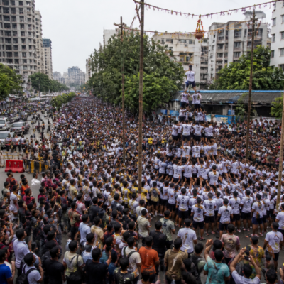 Govinda teams gather near a road closure during Dahi Handi celebrations in Thane
