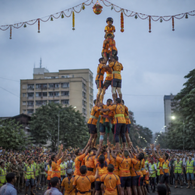 Govinda participants forming a human pyramid during a Dahi Handi celebration in Vasai-Virar