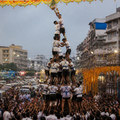 Govinda participants forming a human pyramid during a crowded Vasai Virar Dahi Handi celebration