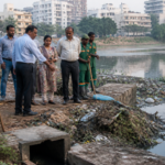 Civic workers clearing waste near Agara Lake in Bengaluru during an inspection of waste collection and lake maintenance