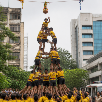 Govinda participants forming a human pyramid during a Dahi Handi event in Thane