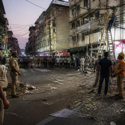 People gather near the Line Ali area in Panvel after an electrocution incident during a Dahihandi celebration
