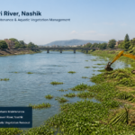 Landscape image of Godavari River near Nashik showing aquatic vegetation and riverbank maintenance work for vegetation removal tender