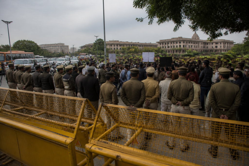 Jantar Mantar protest site in Delhi with police barricades and demonstrators near public buildings