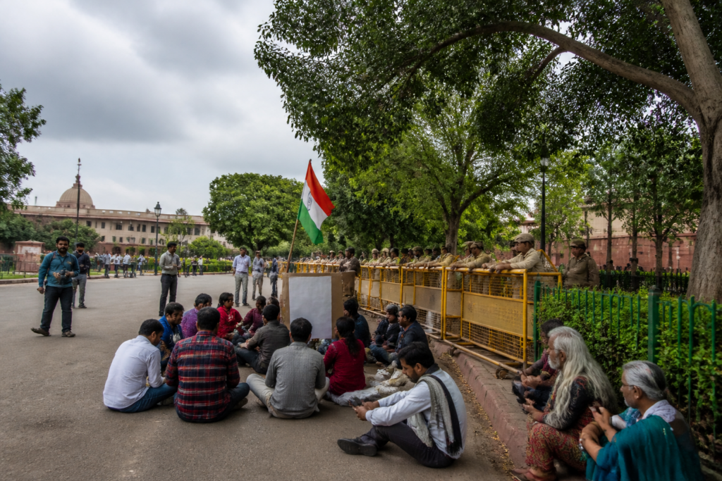 Jantar Mantar protest site in Delhi with police barricades and demonstrators