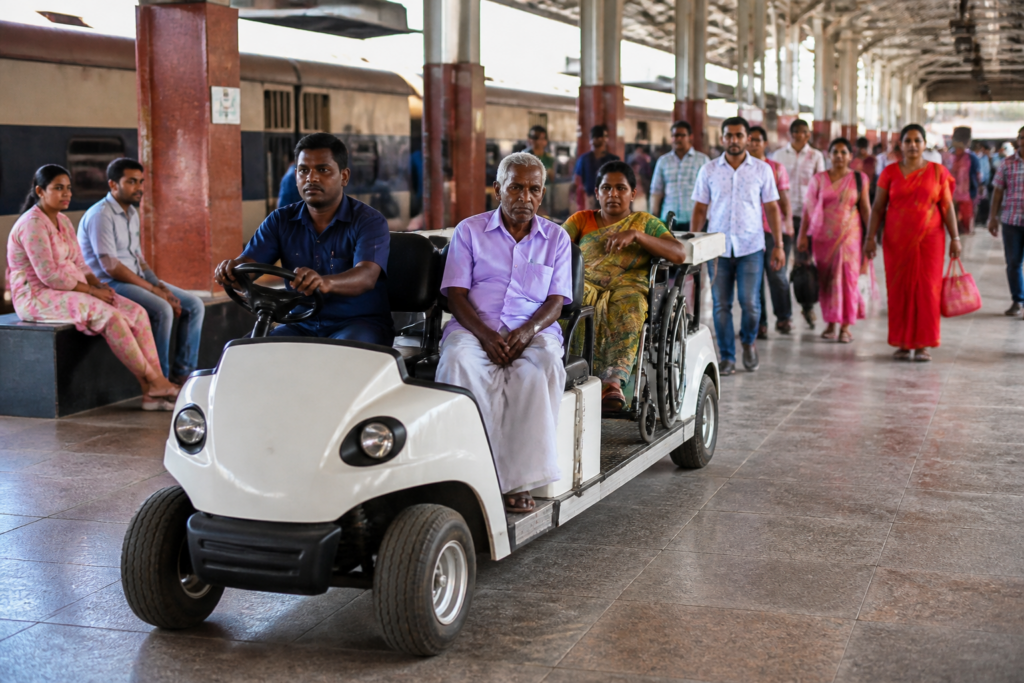 Railway battery car service assisting passengers at an Indian railway station