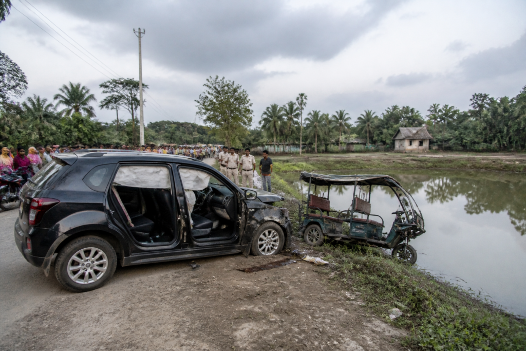 Sandeshkhali crash scene near a pond with a damaged SUV and toto