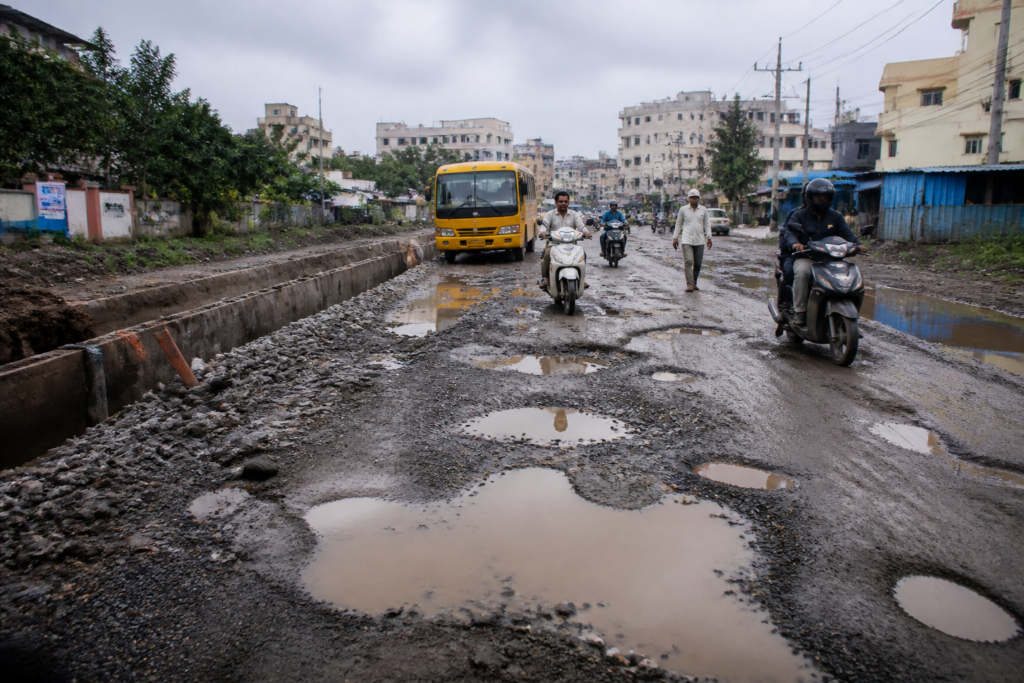 Pune road potholes and slush covering Diamond Water Park Road between Lohegaon and Wagholi