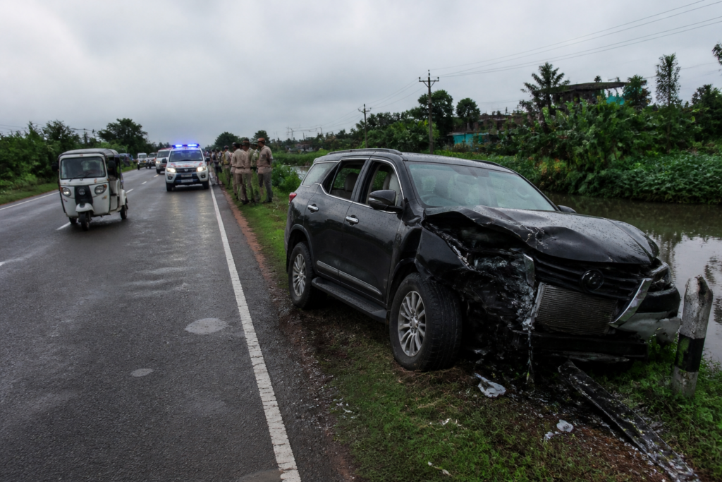 Basanti Highway accident scene with a crashed vehicle near a roadside waterbody