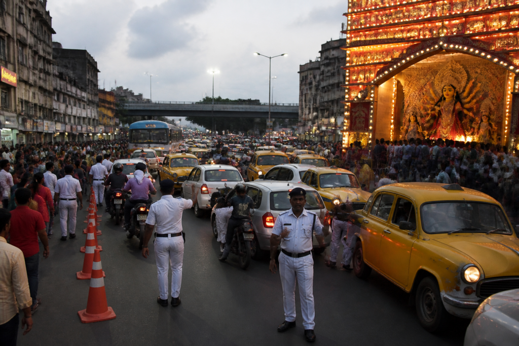 Kolkata traffic plan with police managing crowded Puja-season roads near busy markets and pandals.