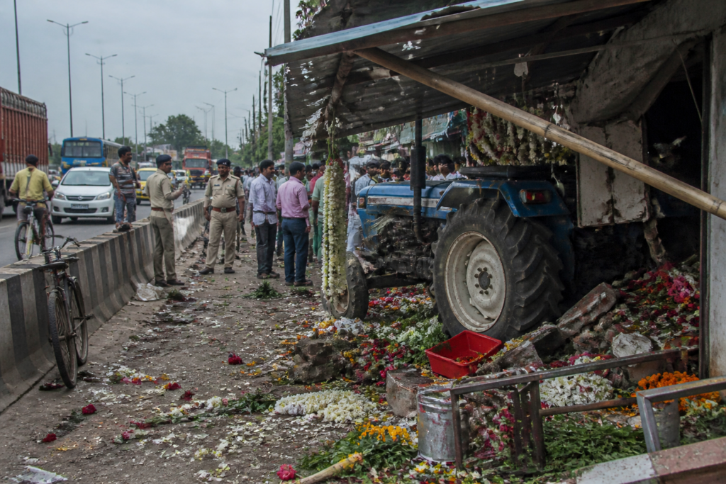 Bardhaman road accident site near GT Road with a tractor and damaged roadside flower shop