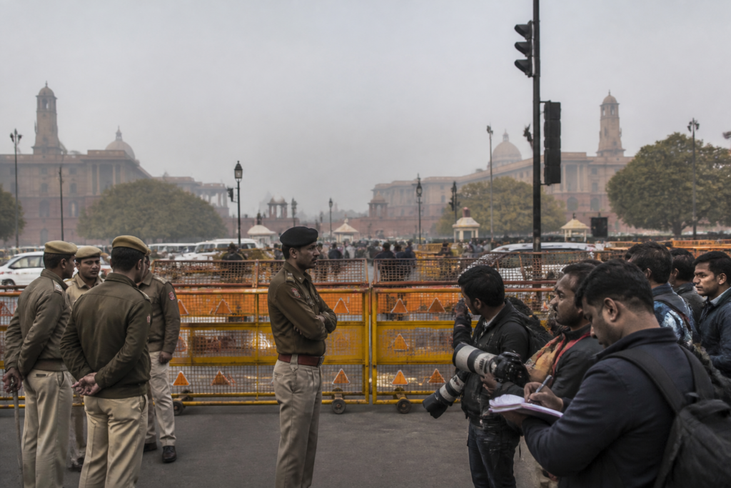 Delhi Police personnel near a protest site after a FIR against three journalists