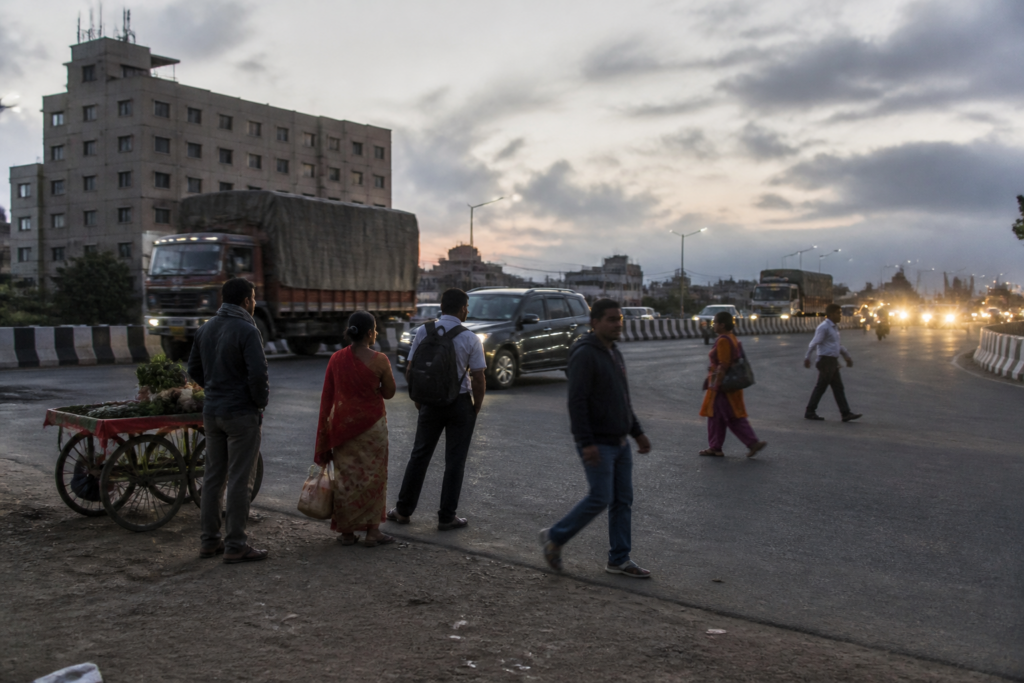 Pune-Solapur Highway accident site near Loni Kalbhor with pedestrians beside heavy traffic