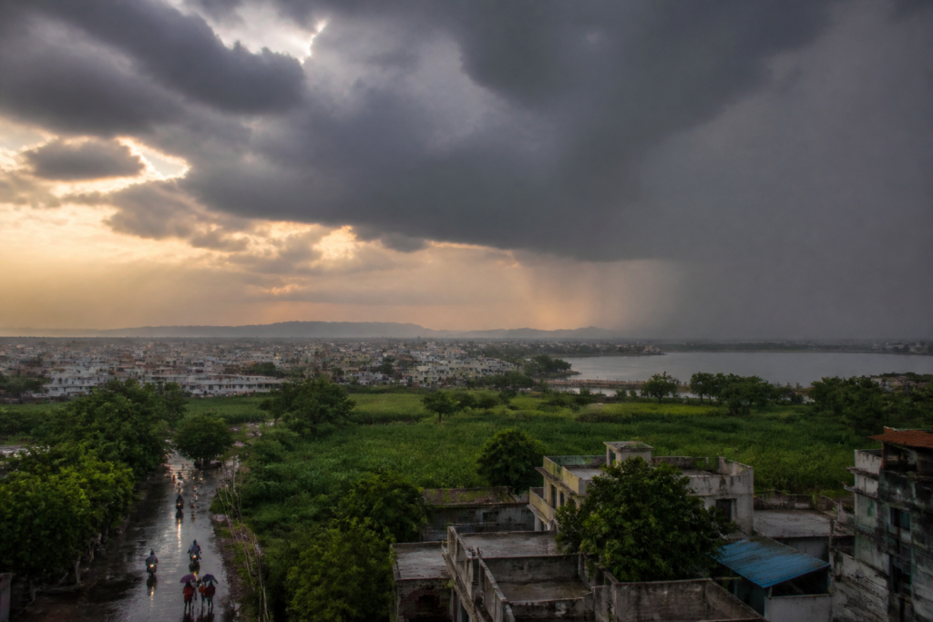 Gujarat rain alert map showing forecast districts alongside Ahmedabad heat conditions