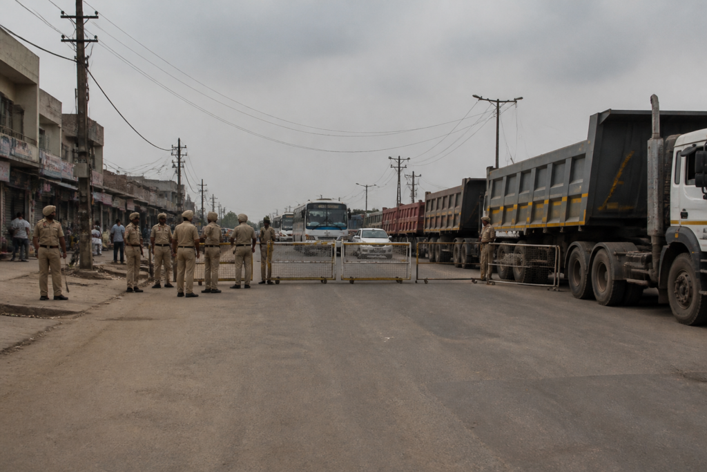 Punjab bandh barricades and police vehicles blocking a road leading to Mansa