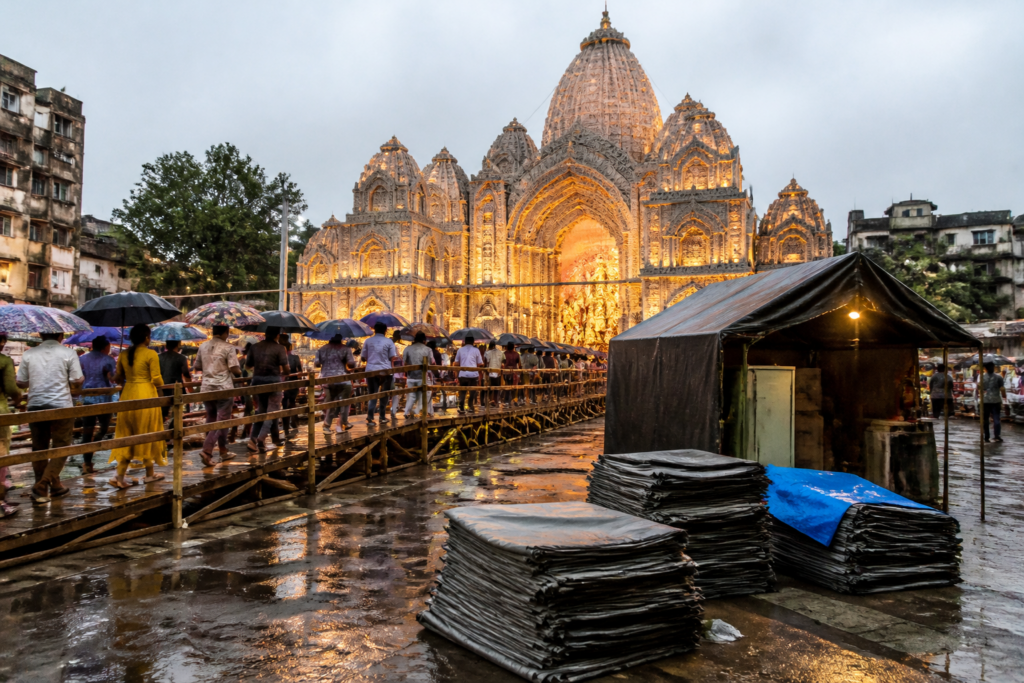 Kolkata Durga Puja pandal with raised visitor platforms prepared for rain