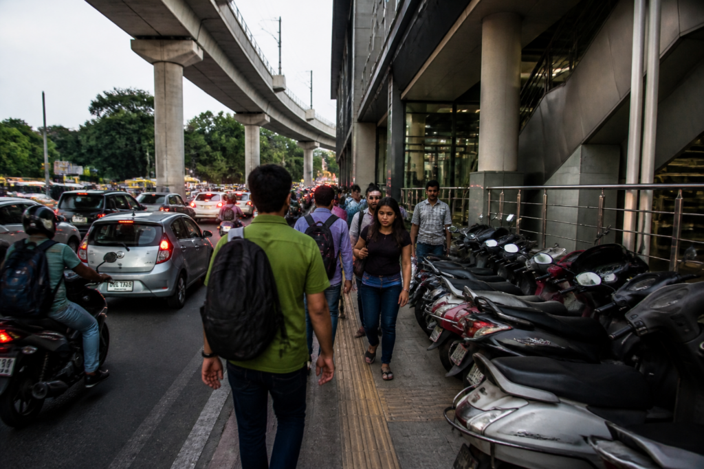 Pune Metro pedestrian safety issues near a station footpath blocked by parked vehicles
