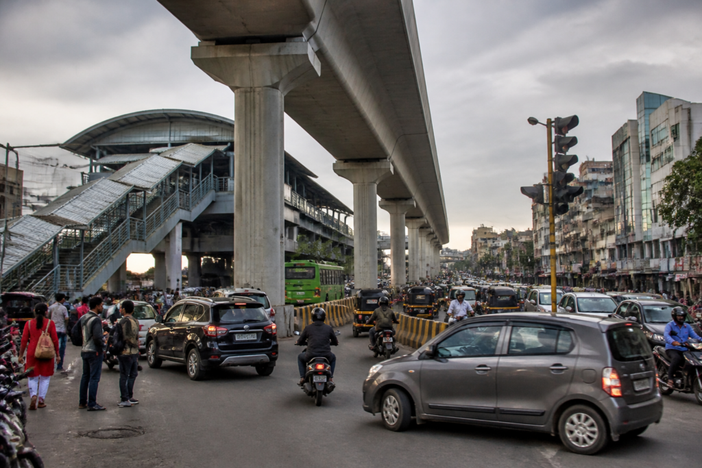 Pimpri-Chinchwad metro pillars narrowing a congested Pune road near a station