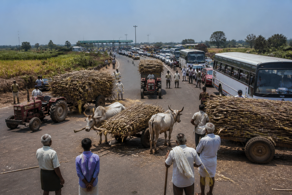 North Karnataka highway blockade causing trucks and buses to queue near a toll plaza