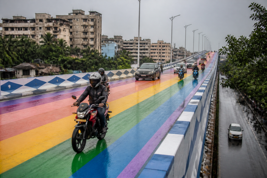 Kolkata rainbow flyovers painted in bright colours with traffic moving during wet weather