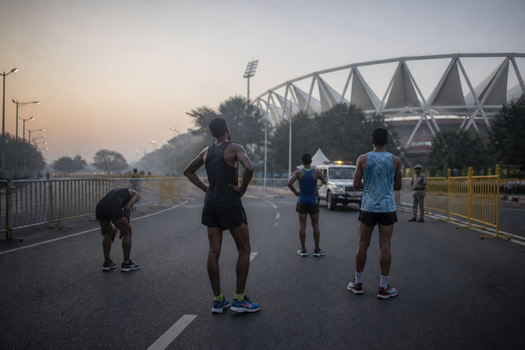 Delhi Half Marathon route near Jawaharlal Nehru Stadium with runners and managed city roads