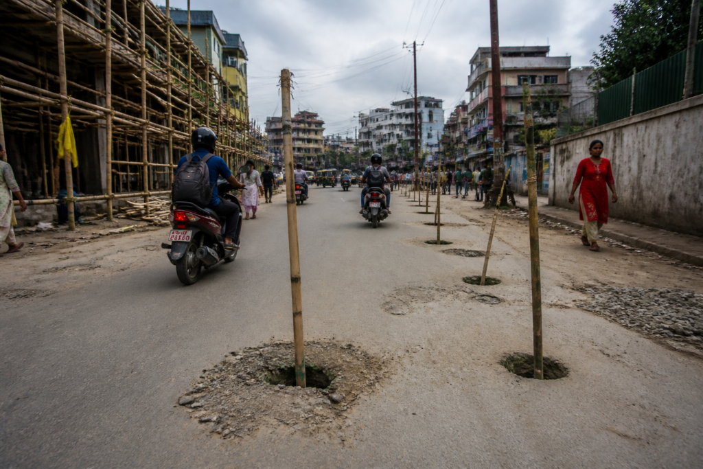 Silchar road damage near Rangirkhari after bamboo poles were installed for a Durga Puja pandal
