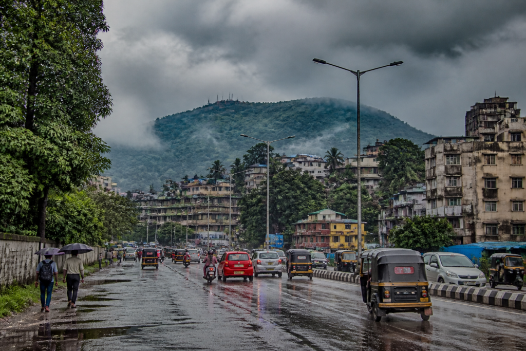 Northeast monsoon withdrawal over Assam with rain clouds and wet urban streets in Guwahati