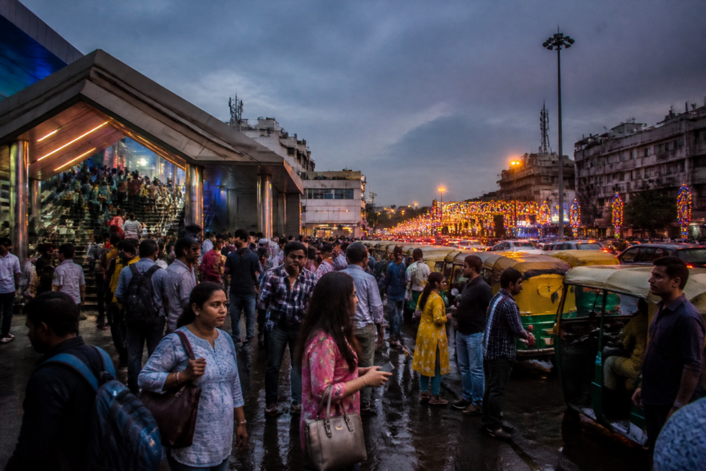 Kolkata auto curbs leave commuters near a metro station searching for transport during Durga Puja.