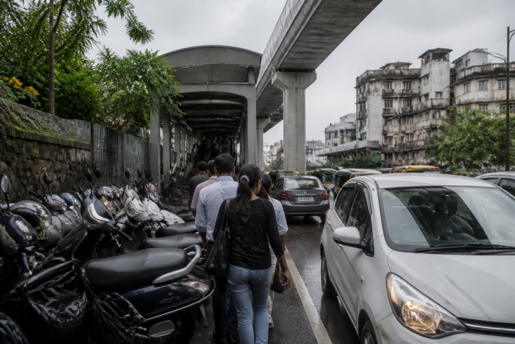 Pune Metro station access blocked by parked vehicles and a narrow footpath