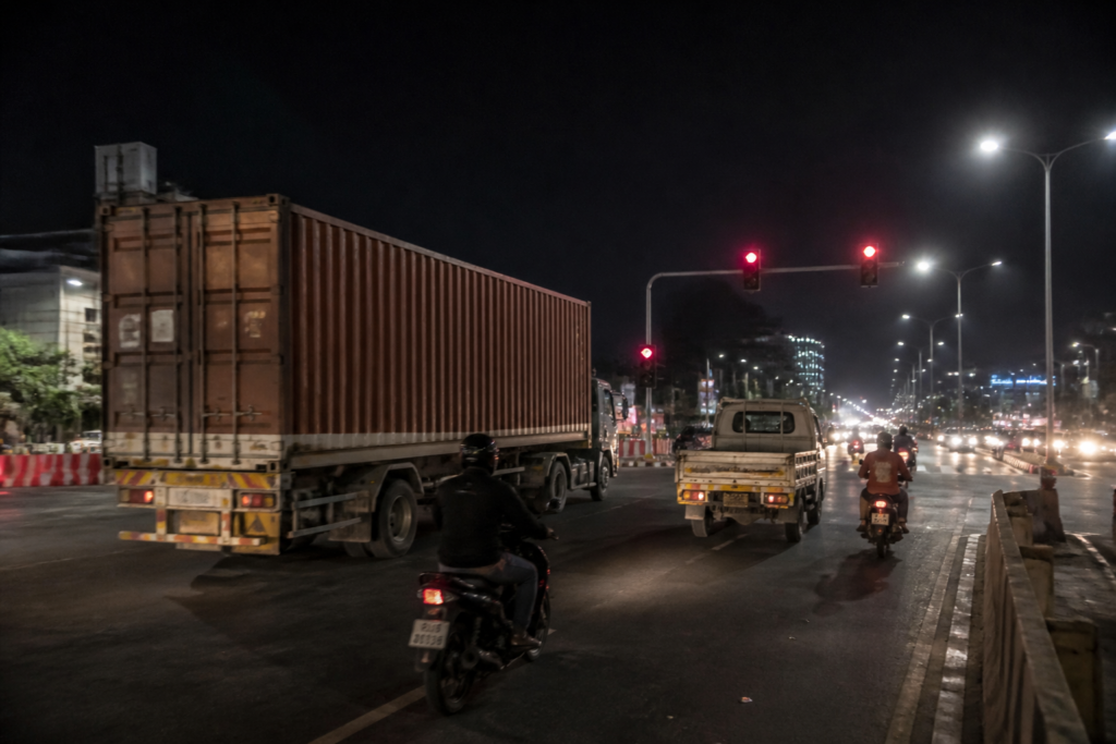 Ahmedabad road accidents on a busy ring road with motorcycles and heavy vehicles at night
