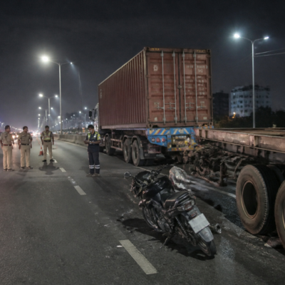Ahmedabad road accidents involving motorcycles and heavy vehicles on a city road