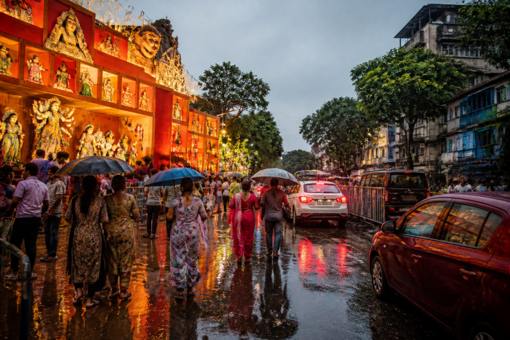 Kolkata Puja weather forecast as visitors walk near decorated pandals under cloudy skies