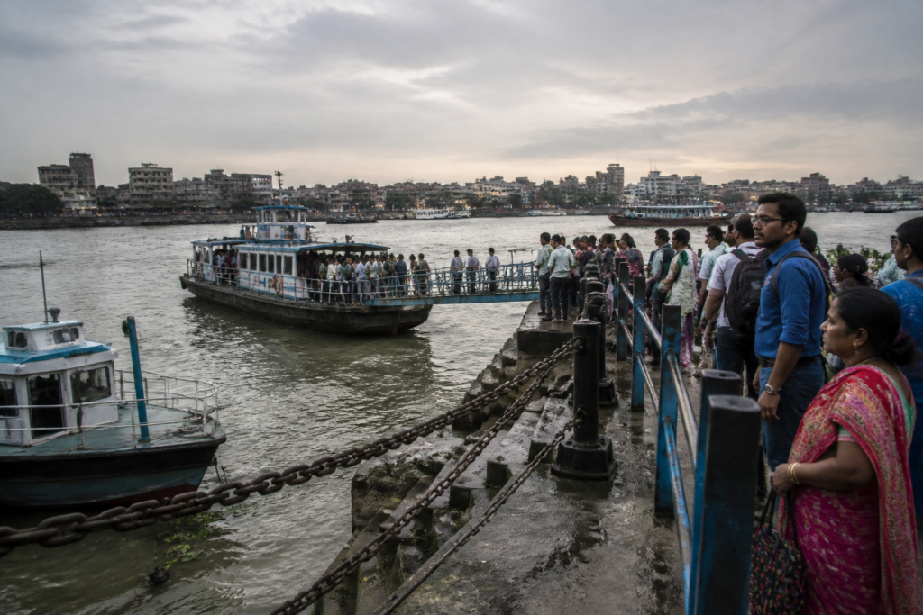 Howrah Kolkata ferry service launches on the Hooghly River near a busy ghat