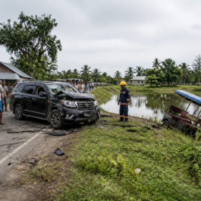 Sandeshkhali road accident site near a roadside pond with an e-rickshaw and SUV