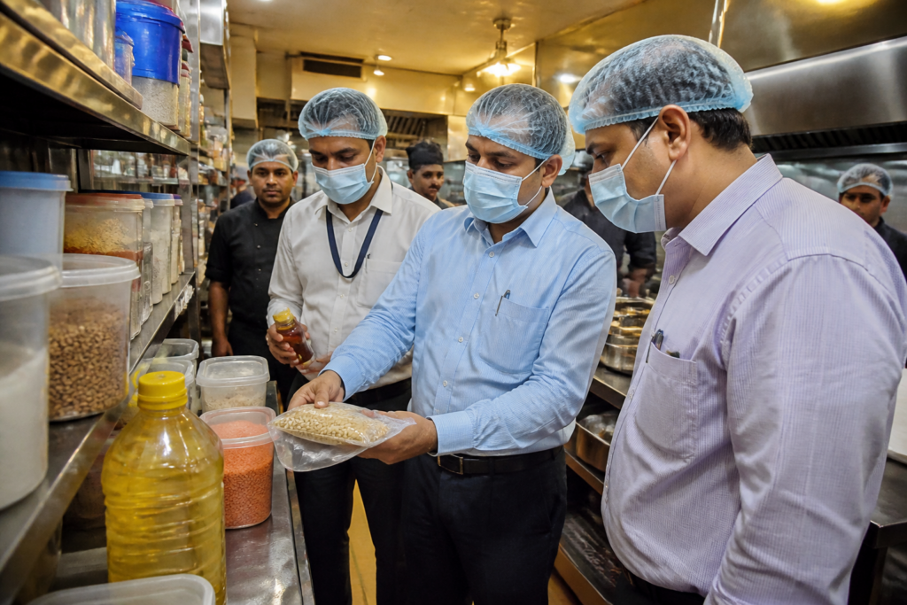 Maharashtra FDA officials inspecting food products at a Mumbai establishment