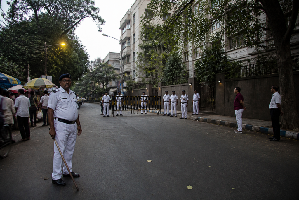 Kolkata Police personnel outside a residential area linked to the civic volunteer case
